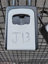 These are the traditional "Lockboxes" that hold your electronic keys.  You will get your codes only a few hours before your arrival.  The boxes are locked on to a chain link fence between the two apartment towers.