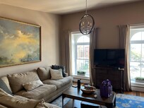 The beautiful Living room area with a Smart TV. Gorgeous windows overlooking the busy main street.