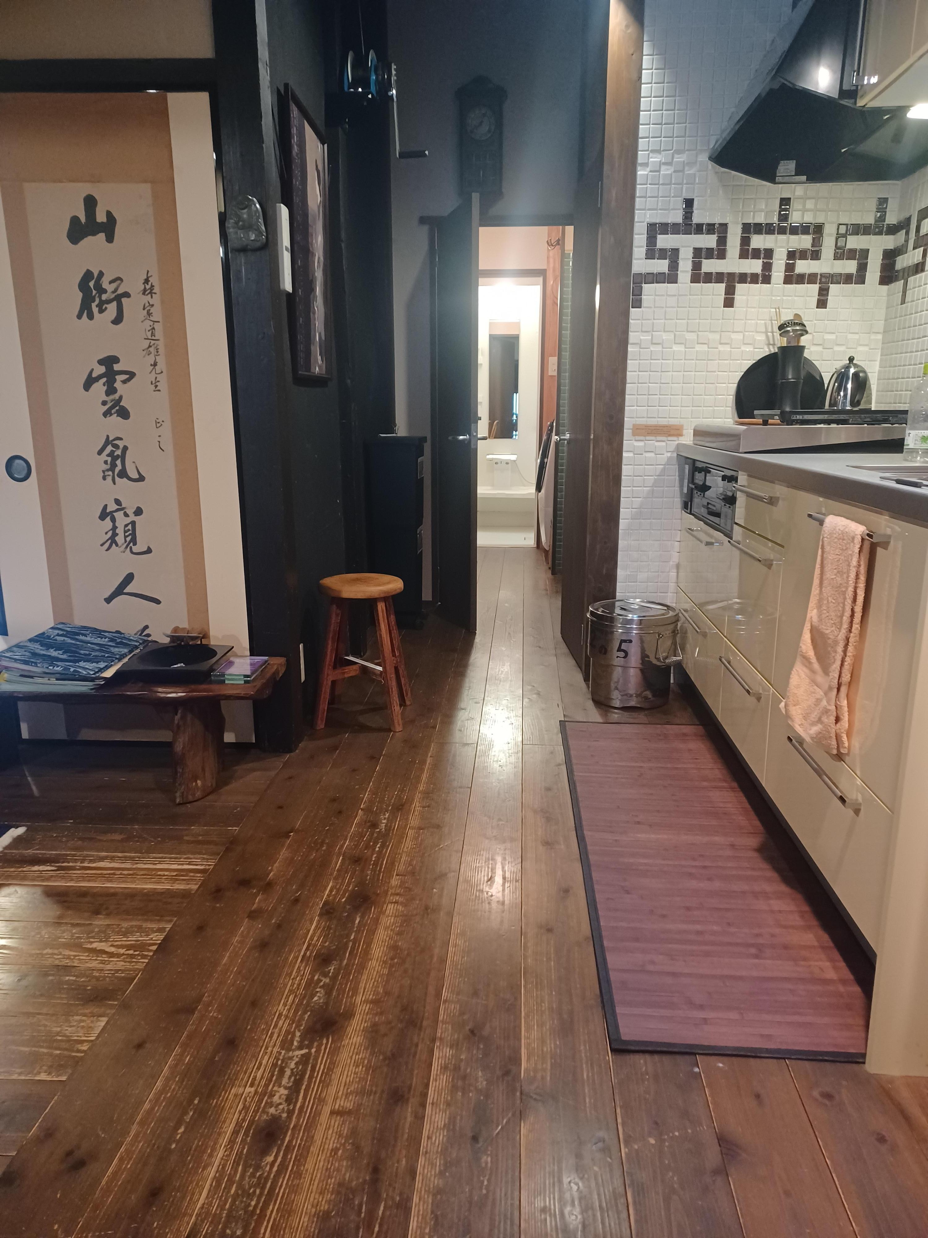 Hallway with kitchen on right, looking back to shower room.
