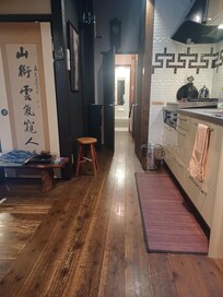Hallway with kitchen on right, looking back to shower room.