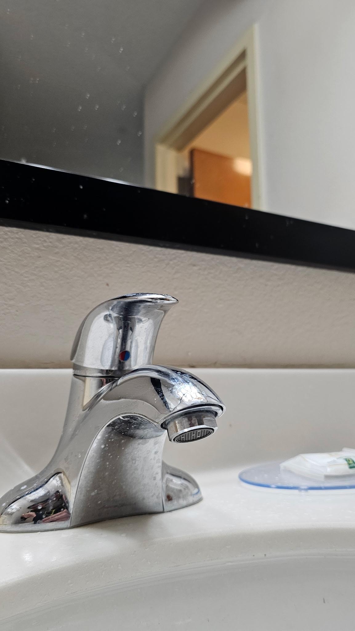 Dirty sink. Toothpaste still visible from last guest.