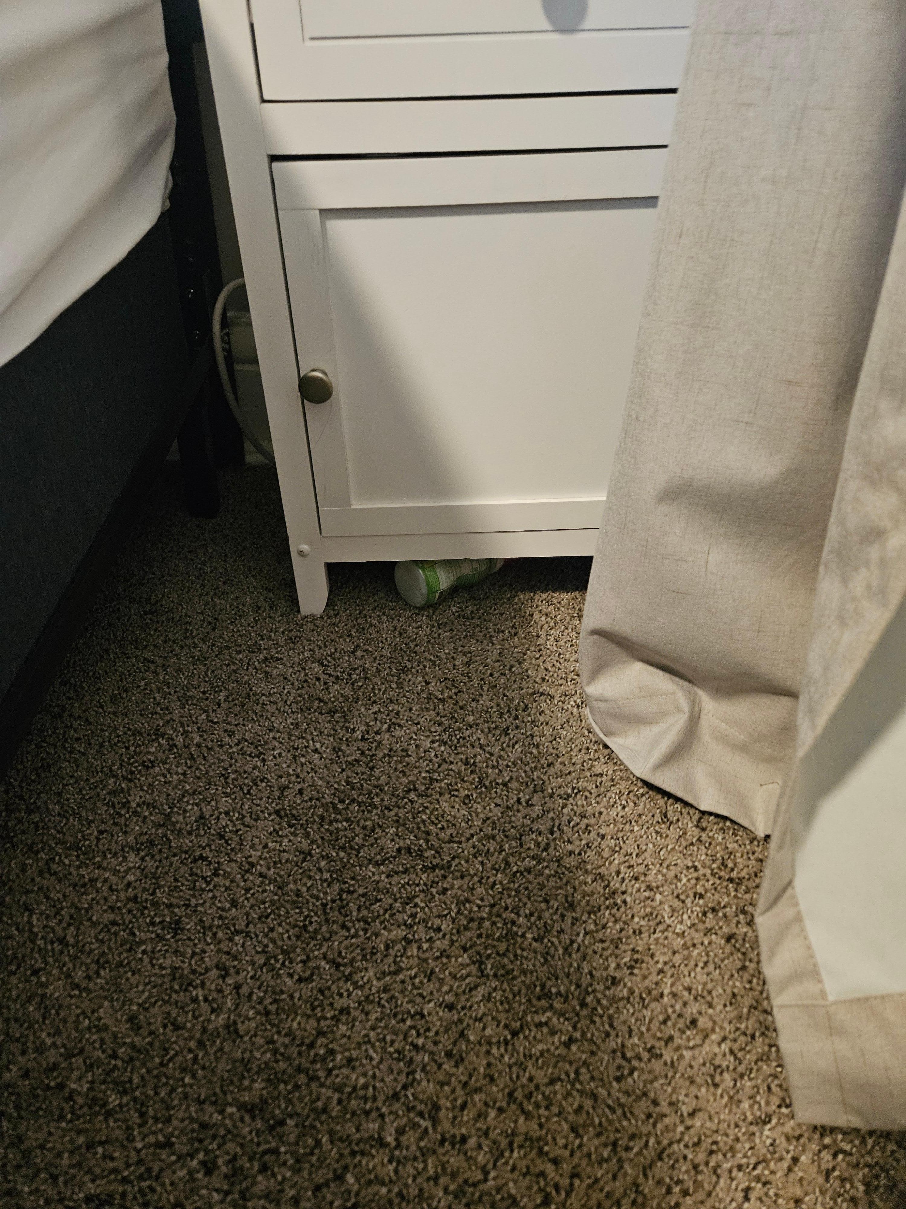 Trash left under nightstand