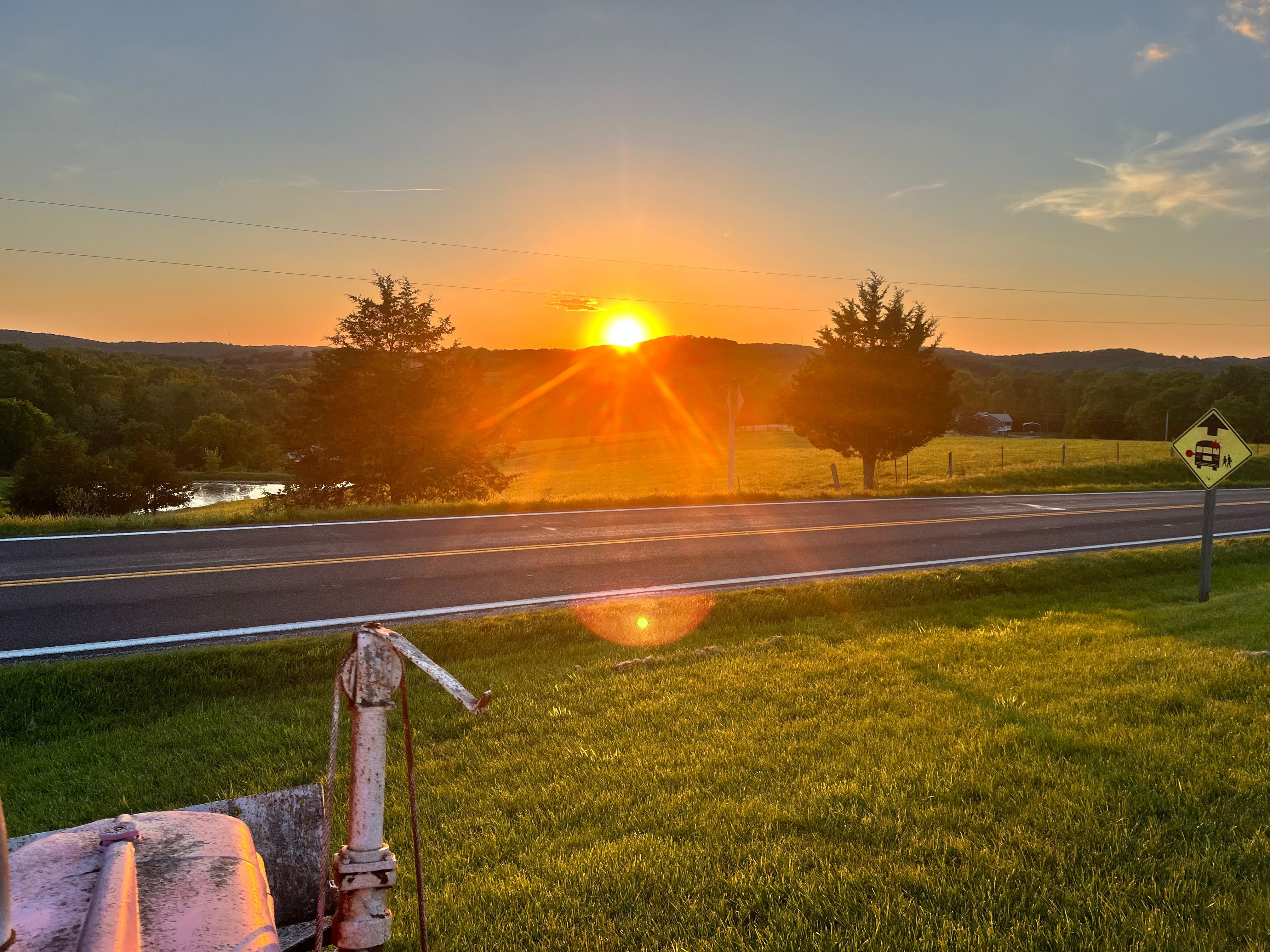 Sunset in front of the pink tractor.