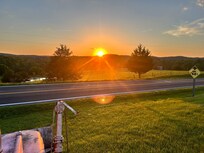 Sunset in front of the pink tractor.