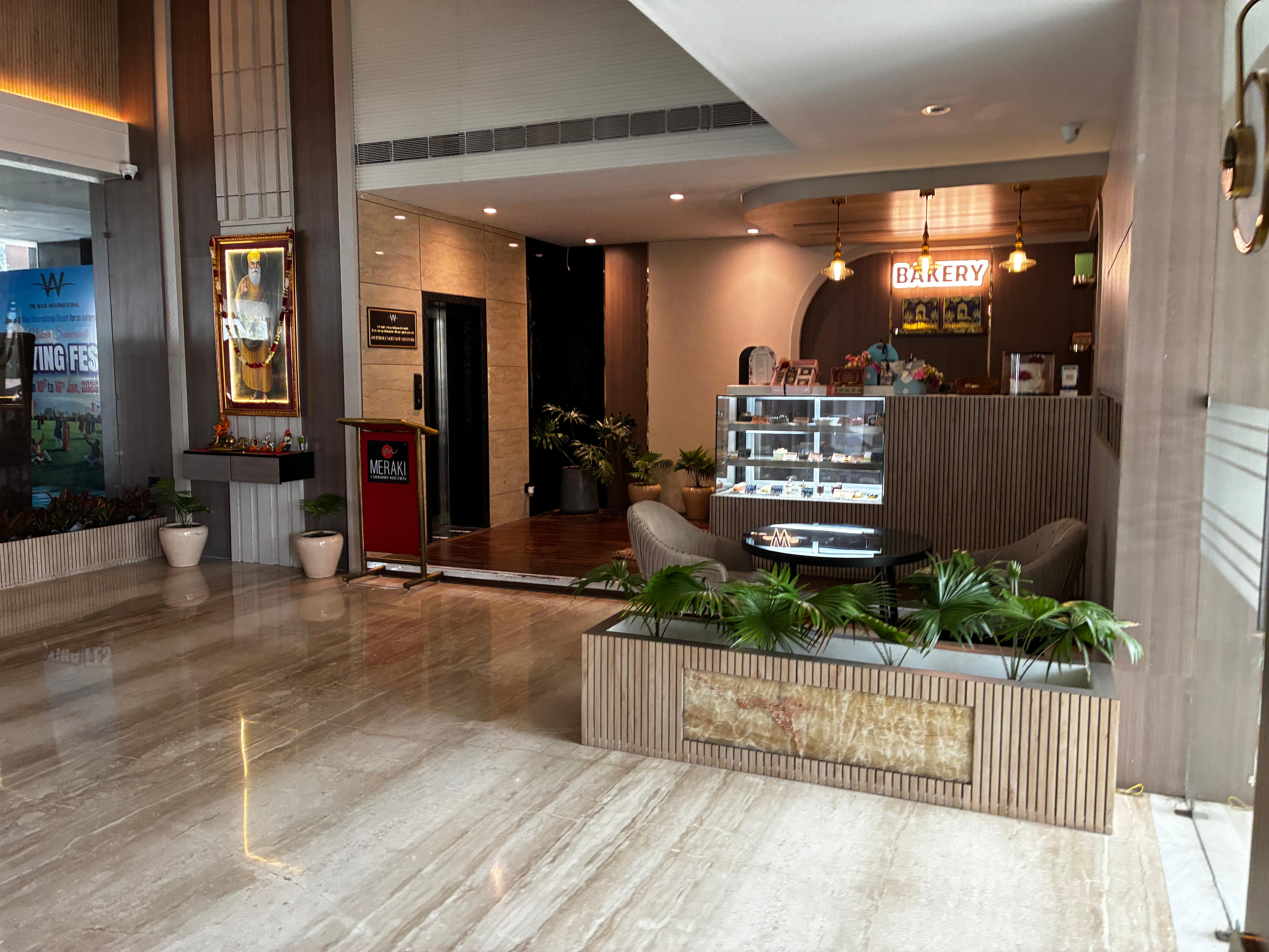 Nice lobby with the  front desk and a bakery 