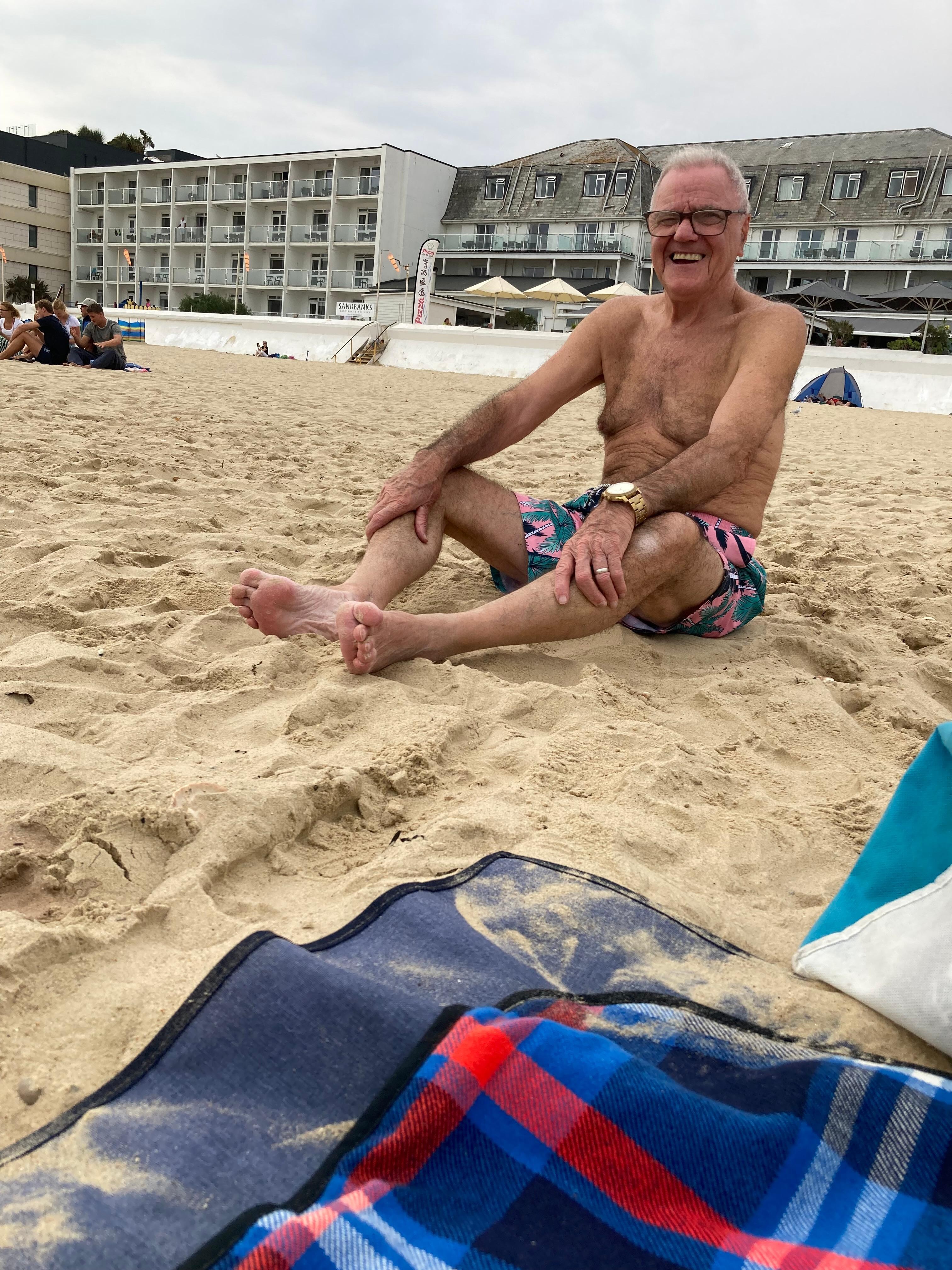 My husband, celebrating his birthday on the beach outside 