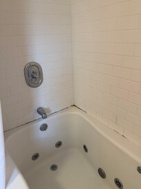 Shower needs to be cleaned and caulked.