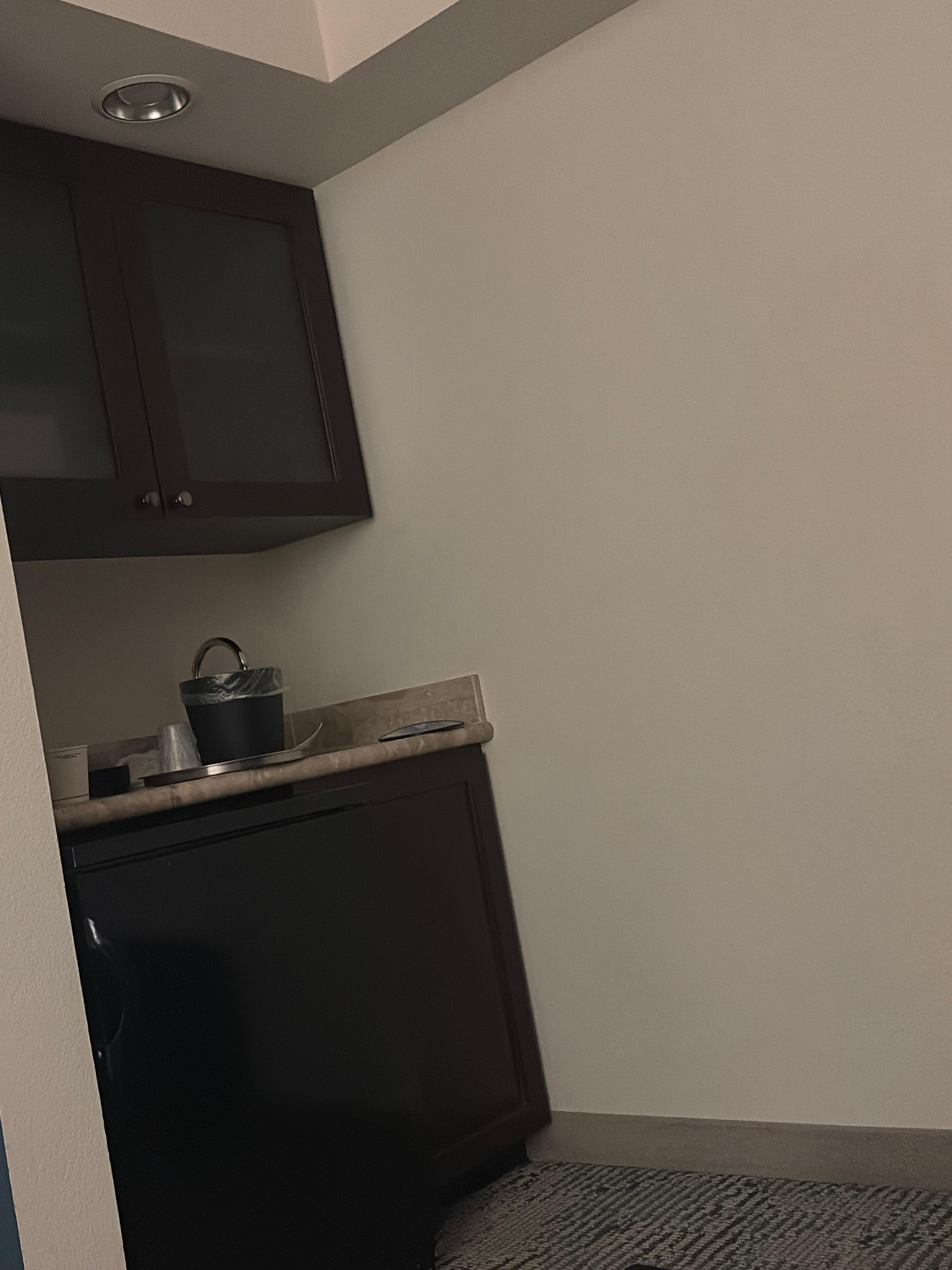 Wet bar with microwave tucked in cabinet 