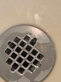 Piece of food in shower. (Pasta)