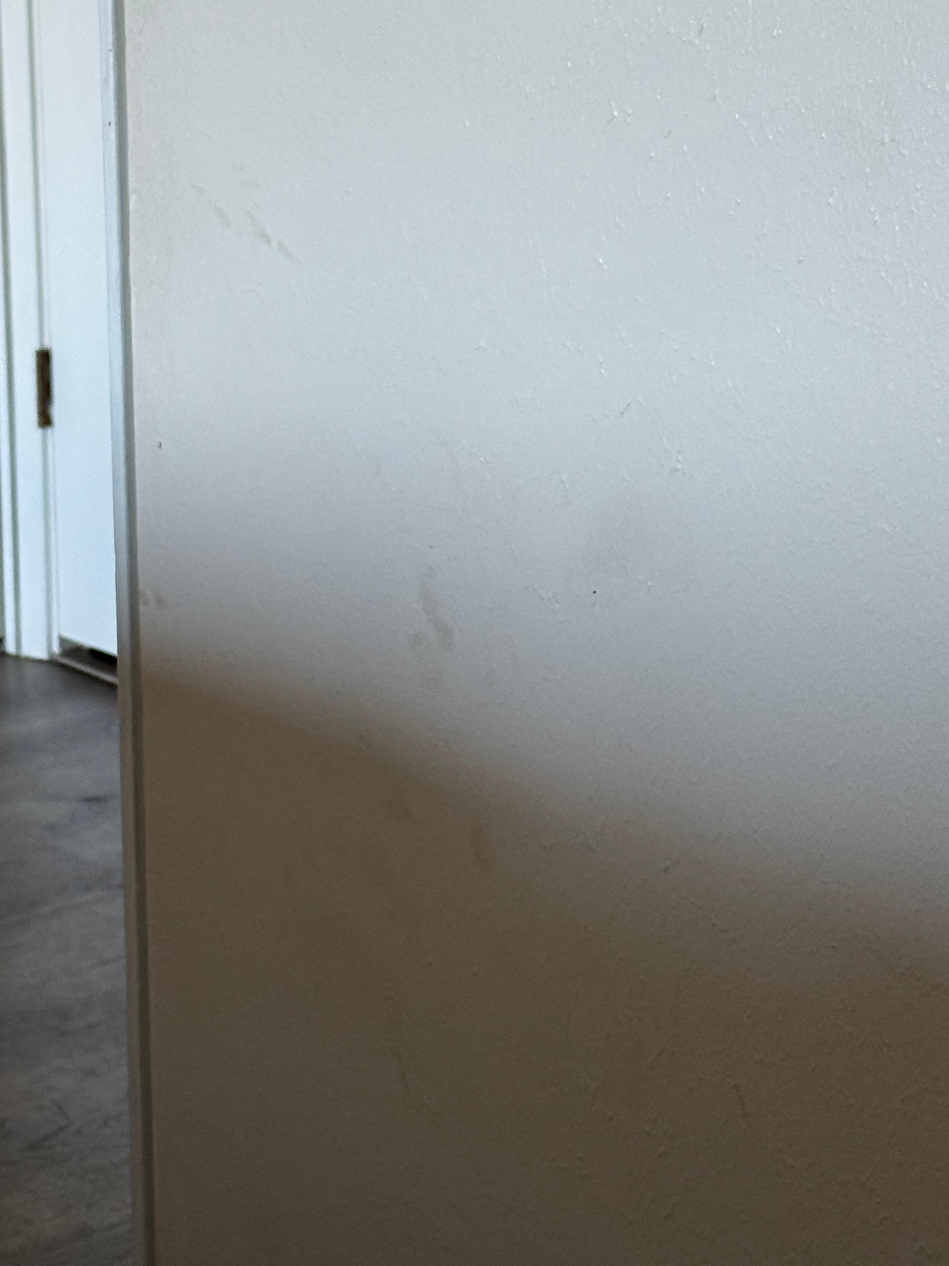 Grime on the wall next to primary bed