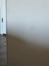 Grime on the wall next to primary bed