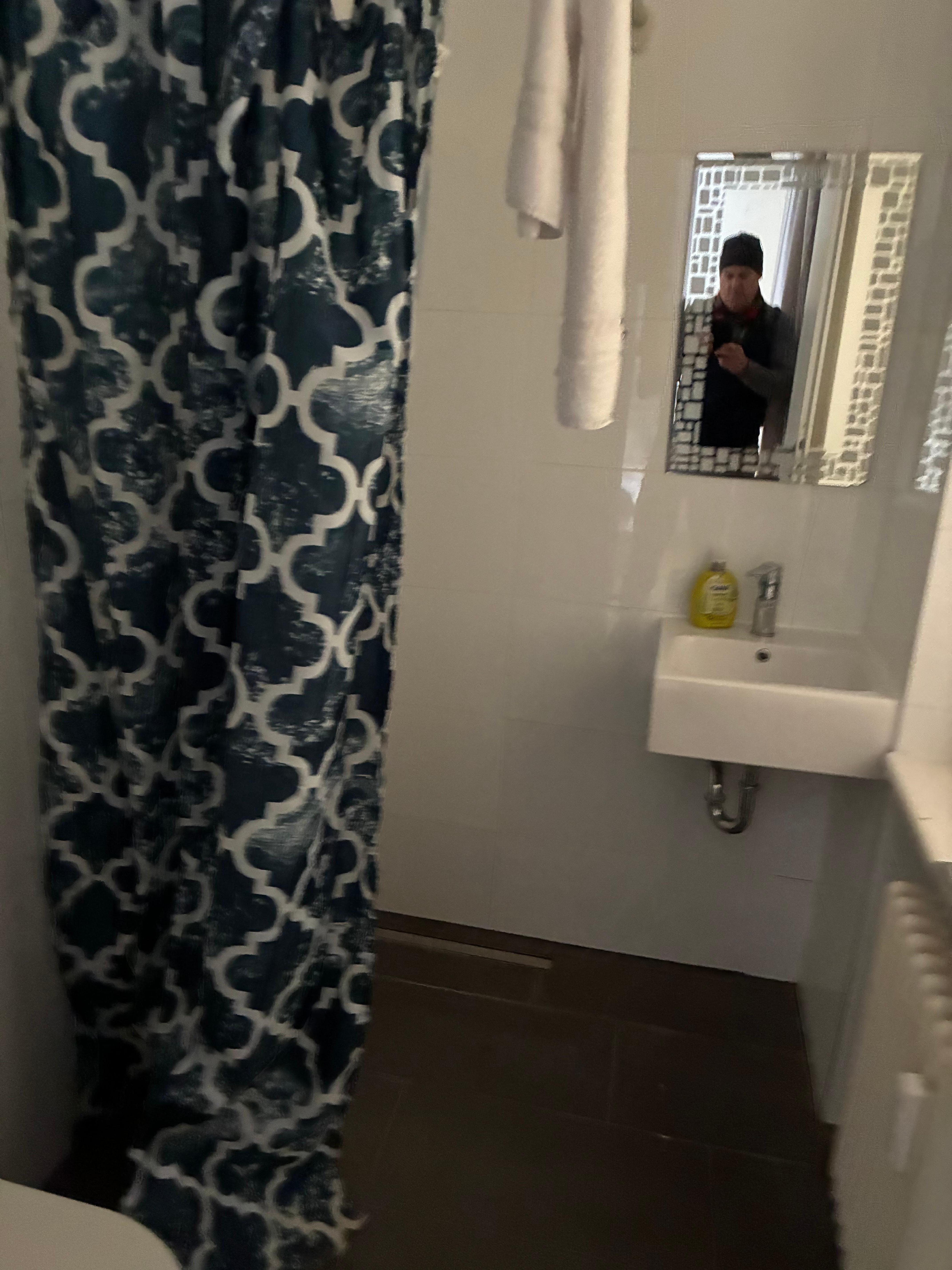 Bathroom - no shower stall, only a shower curtain. 