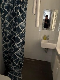 Bathroom - no shower stall, only a shower curtain.
