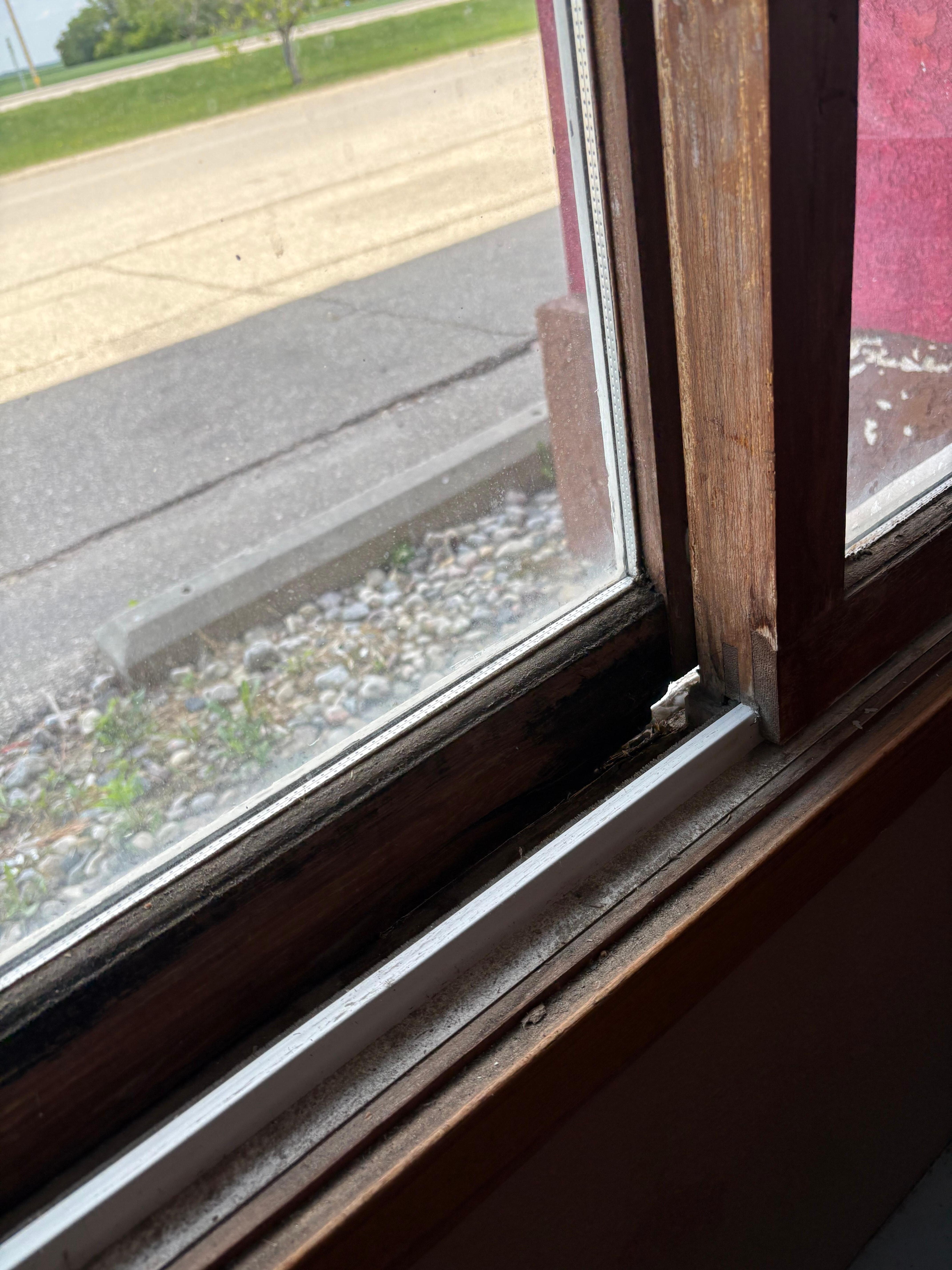 Big hole in window frame. 