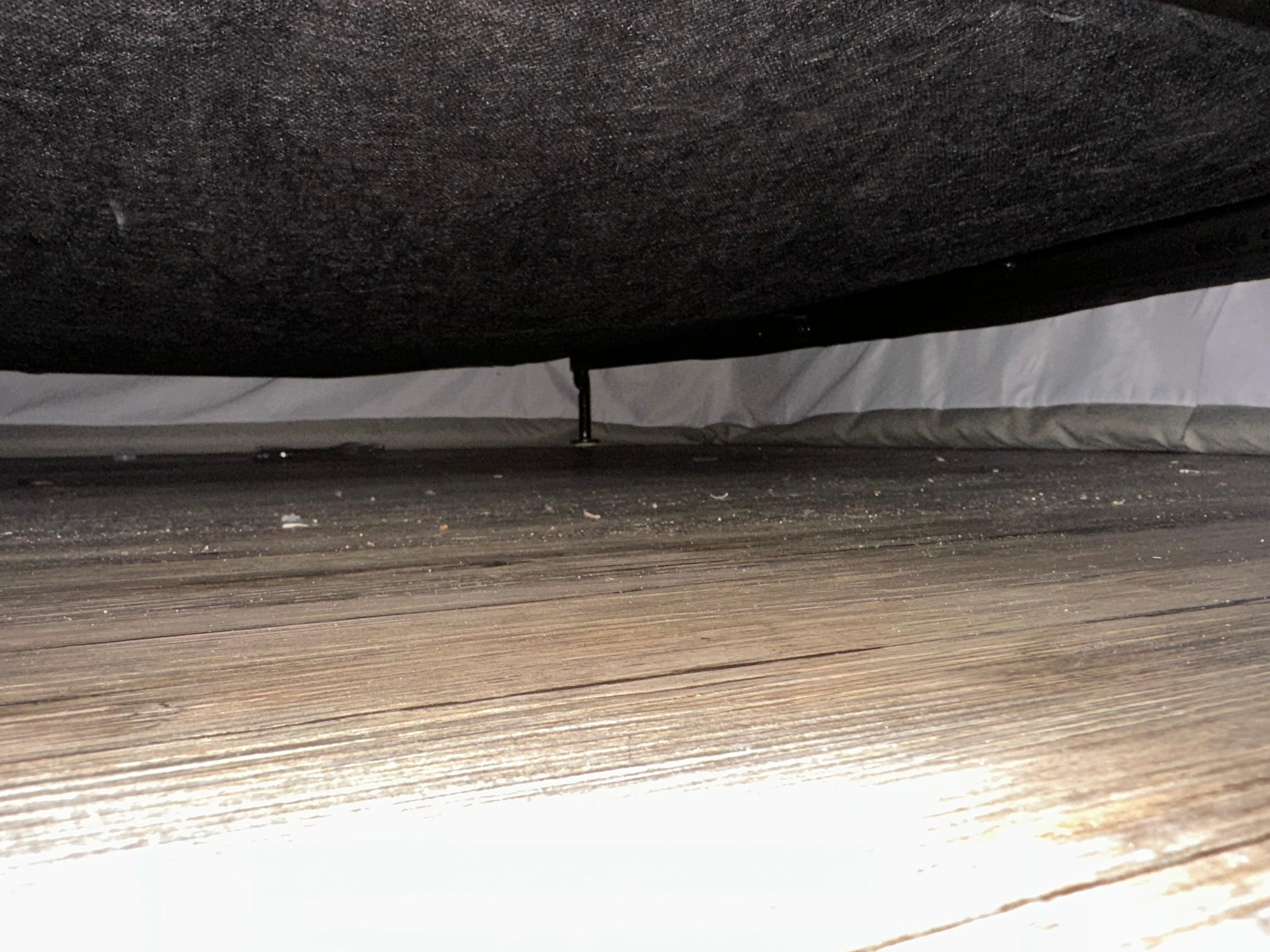 Dirty floor under the bed.