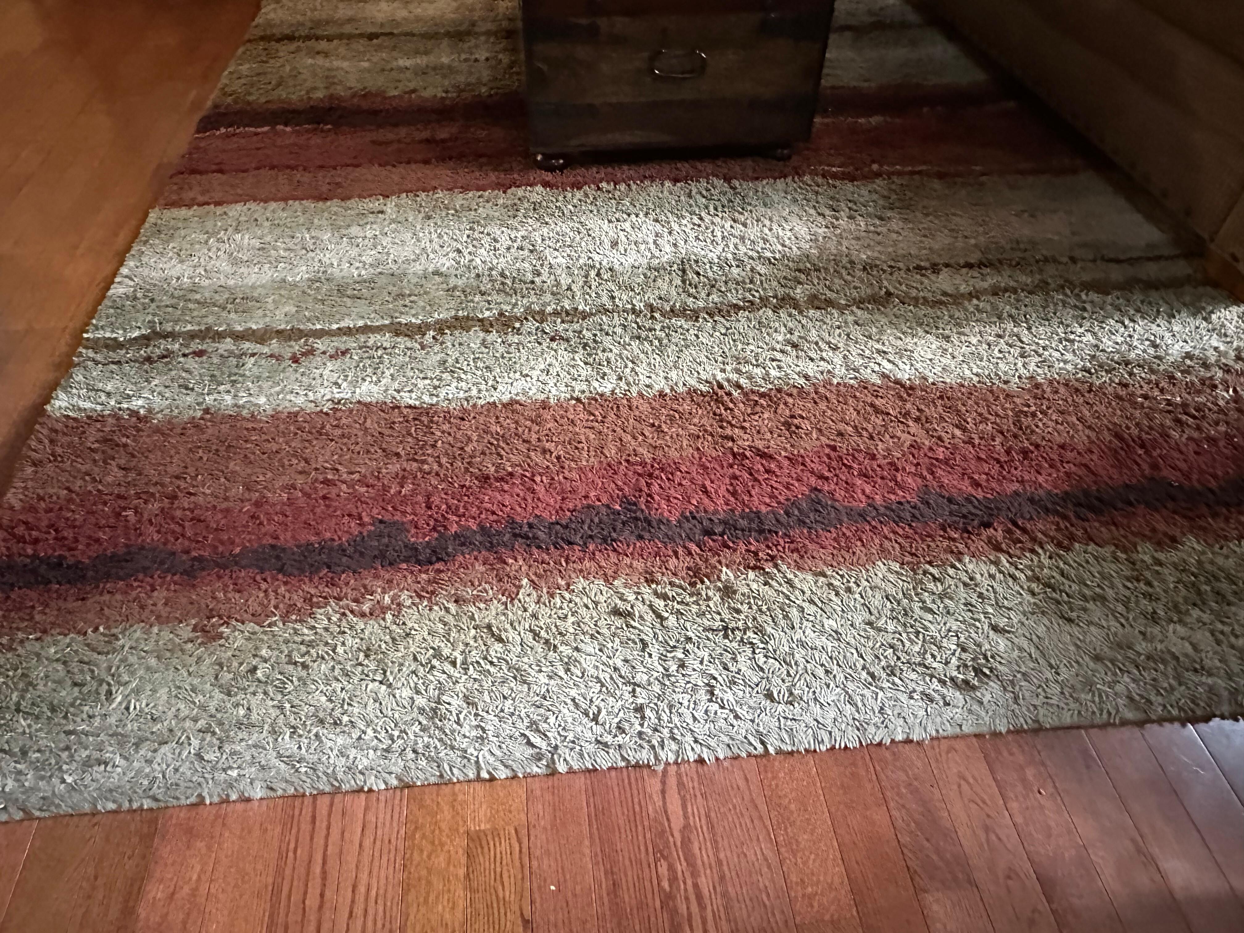 Worn out and dirty rug.  Bathroom rugs in same worn out condition.