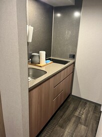 Kitchen area with fridge and microwave in the right.