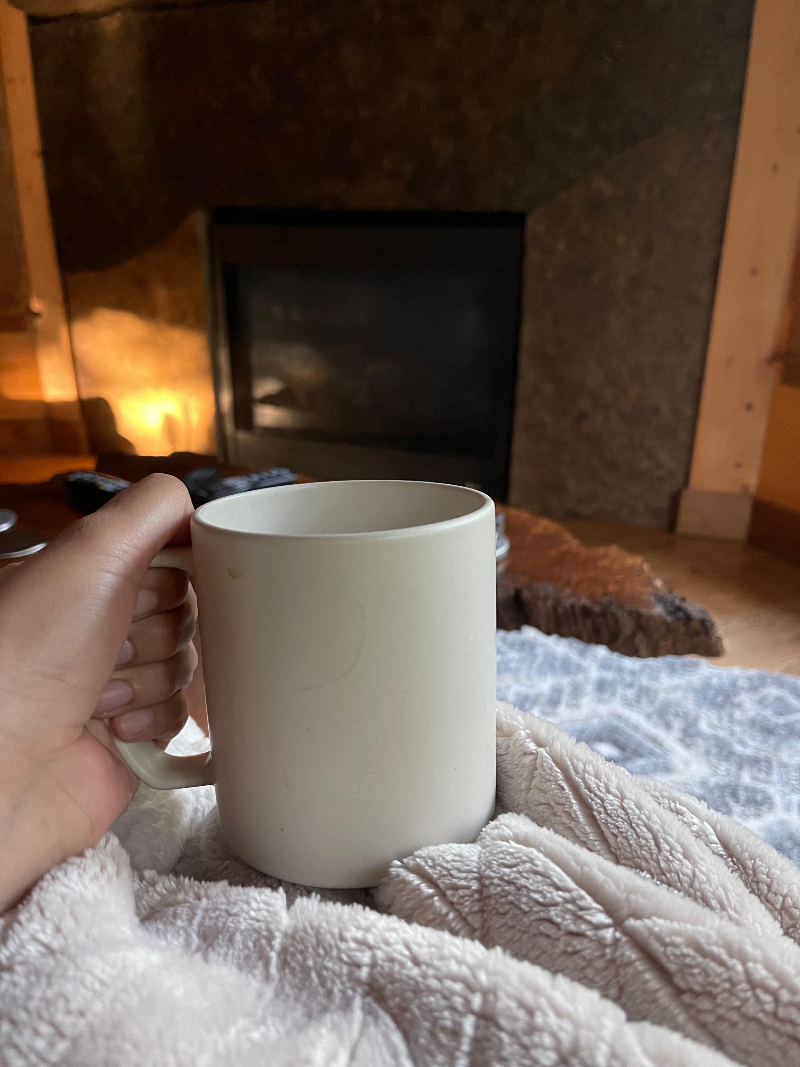 Sitting on the sofa drinking coffee 