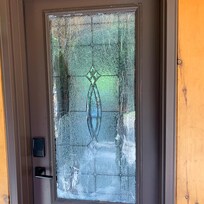 Broken glass taped in front door