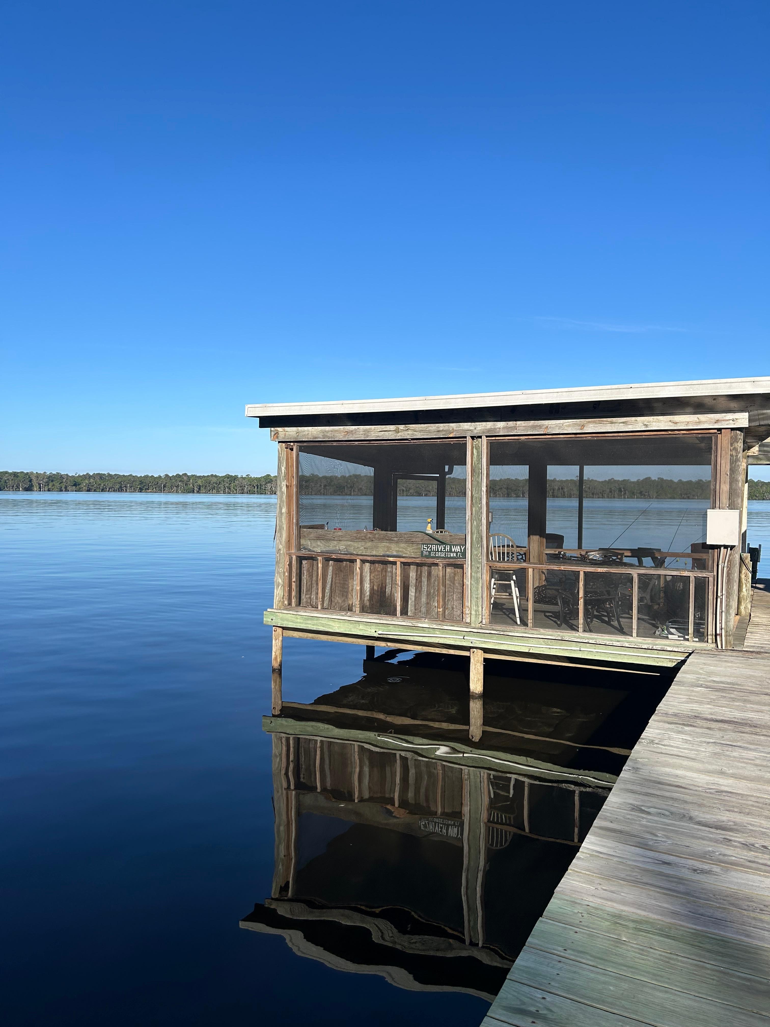 Screened room on the dock with cleaning station. 