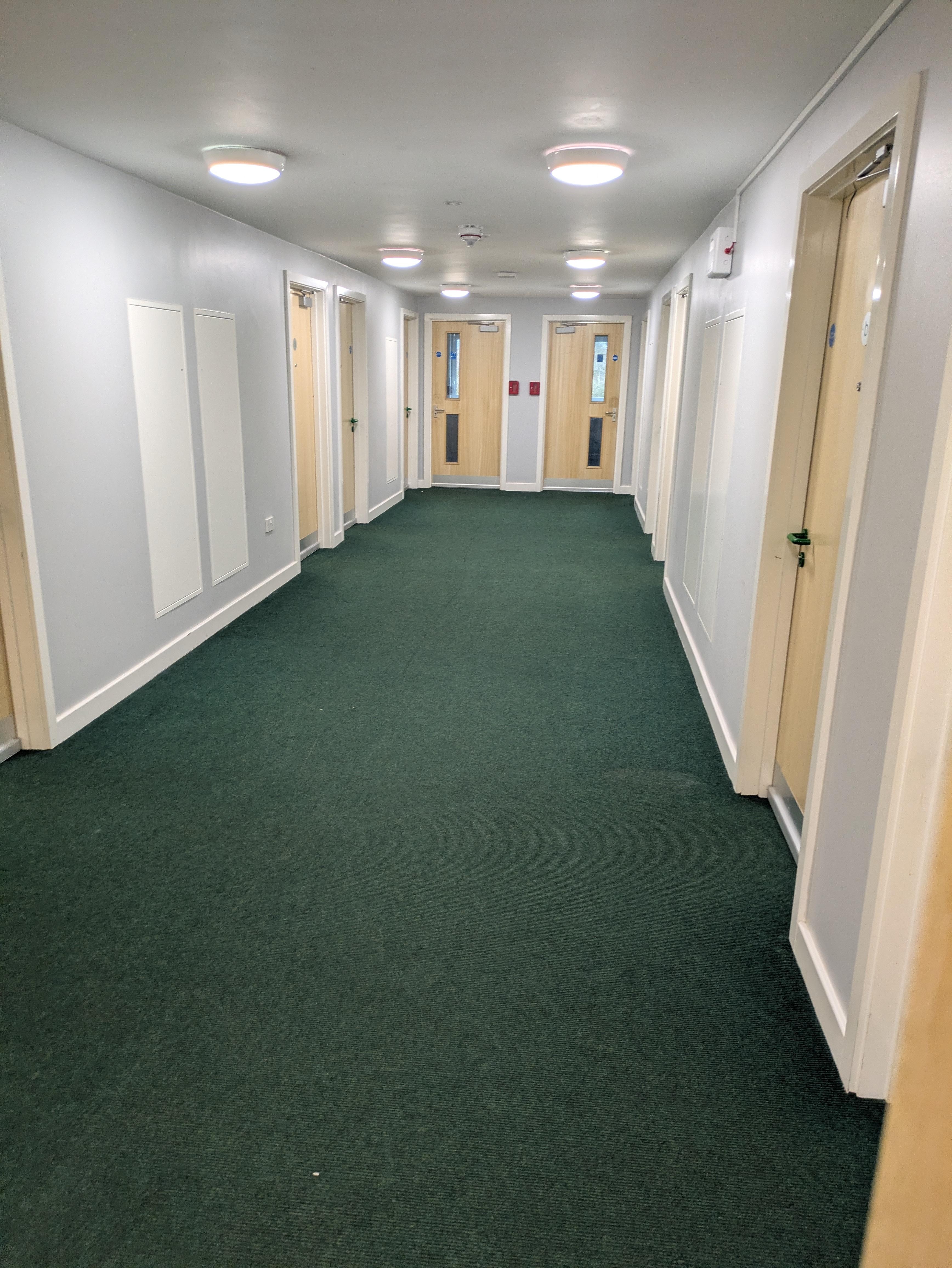The hallway in the flat with individually locked rooms off it