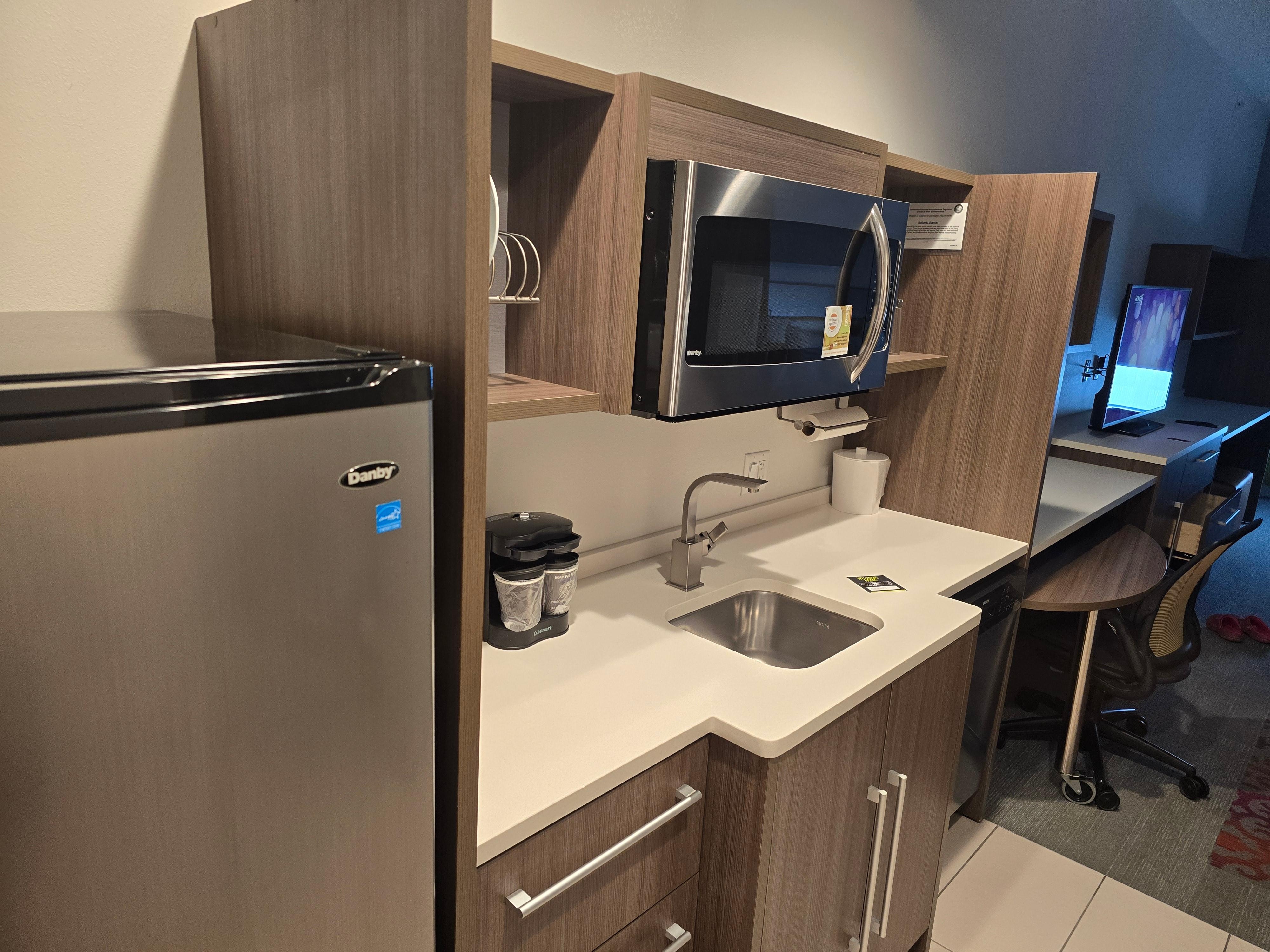 Kitchenette comes with dishes, microwave, coffee maker, and a medium sized fridge/freezer