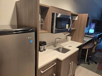 Kitchenette comes with dishes, microwave, coffee maker, and a medium sized fridge/freezer
