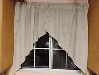 Soiled kitchen window curtain