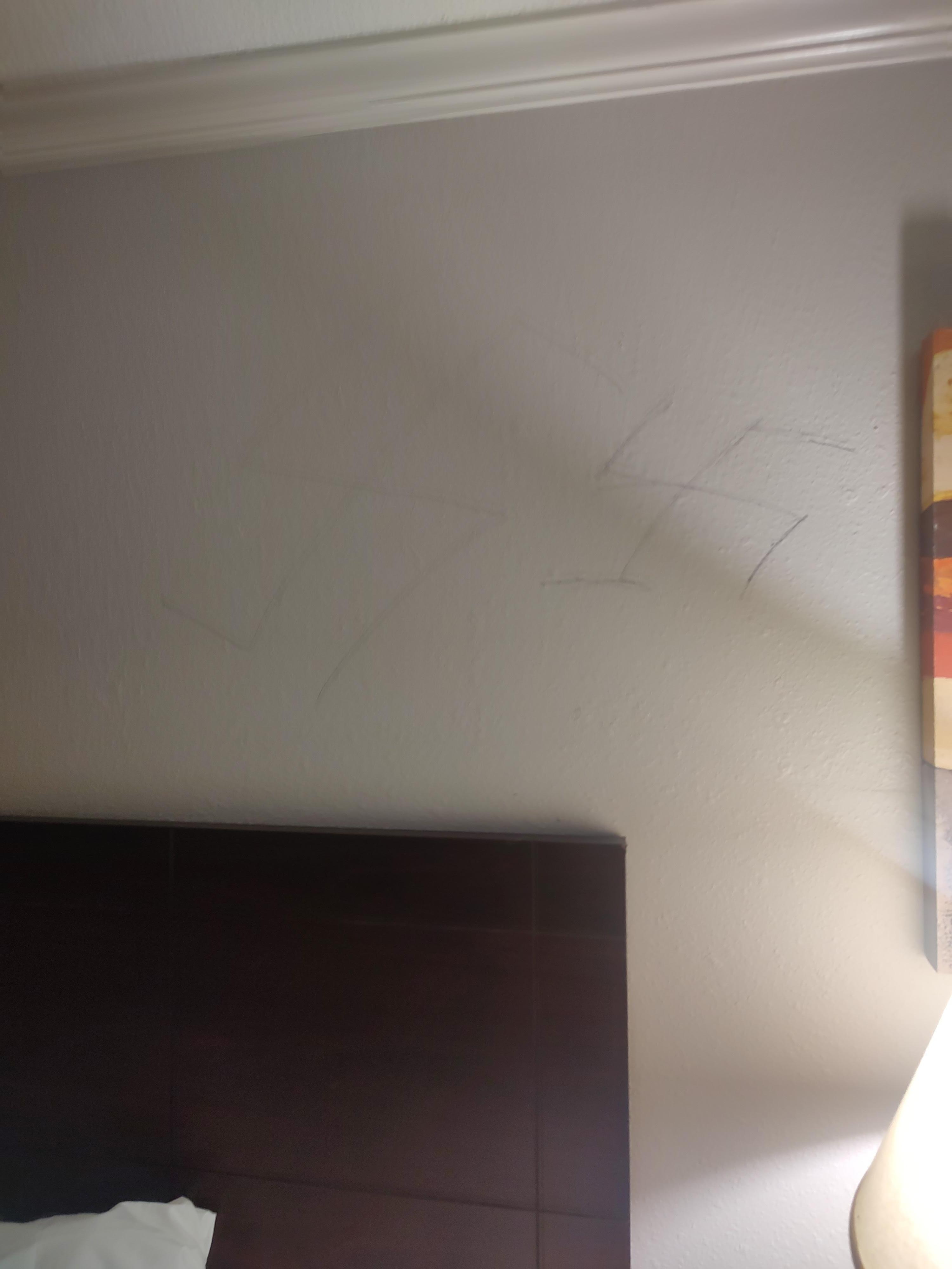 Swastikas drawn on the wall over the bed