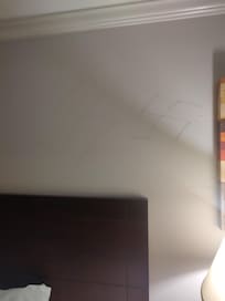 Swastikas drawn on the wall over the bed