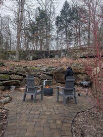 The fire pit/grill area is up against a natural rock formation and is very pretty. The whole yard is very private and serene