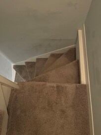 View from up top of the stairs. Clients with physical disabilities would not be able to climb up these stairs to get to the two bedrooms listed.