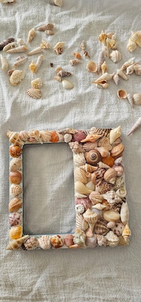 Decorated picture frames with shells we found.
