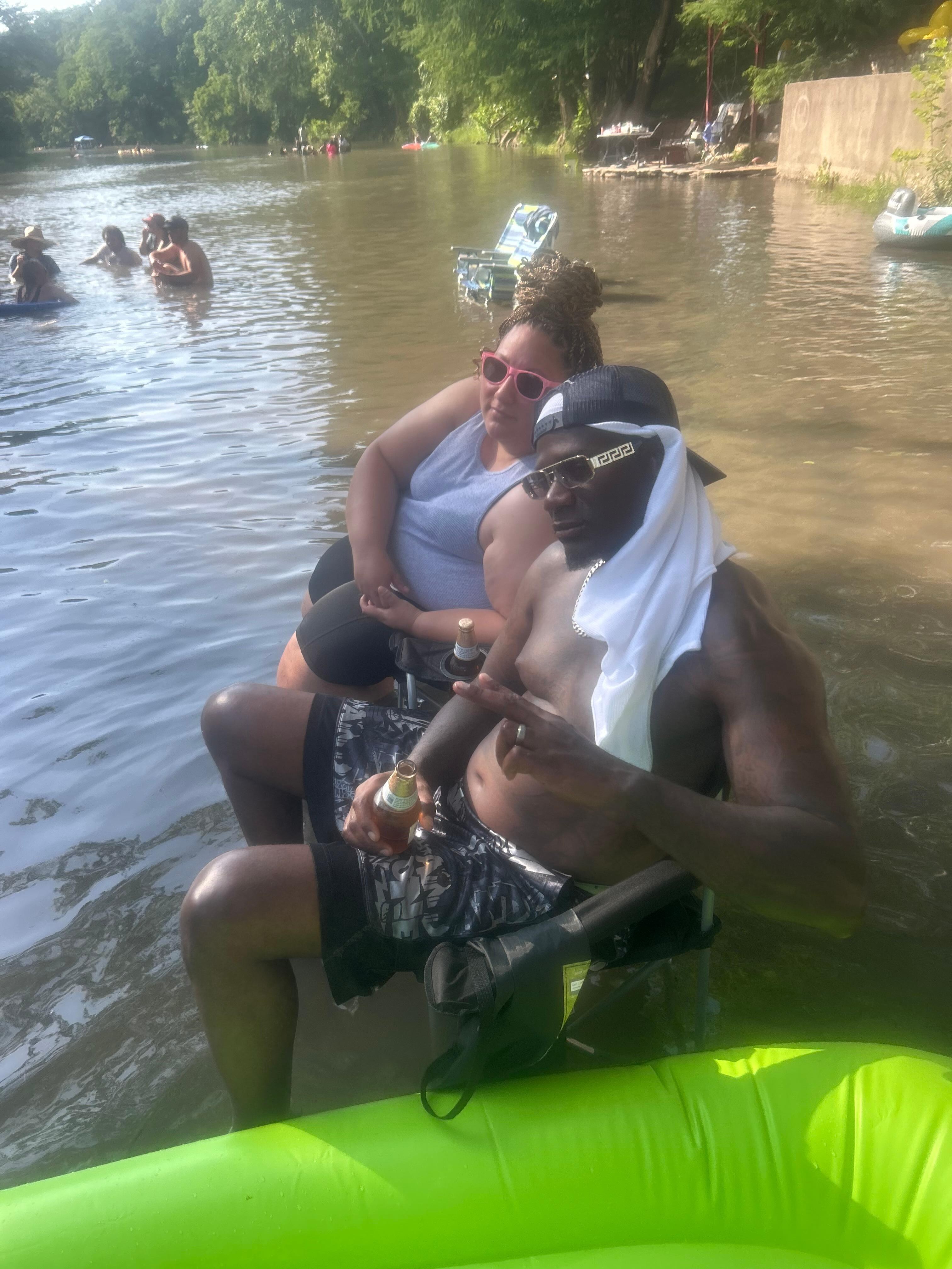 My husband and I sitting at the river