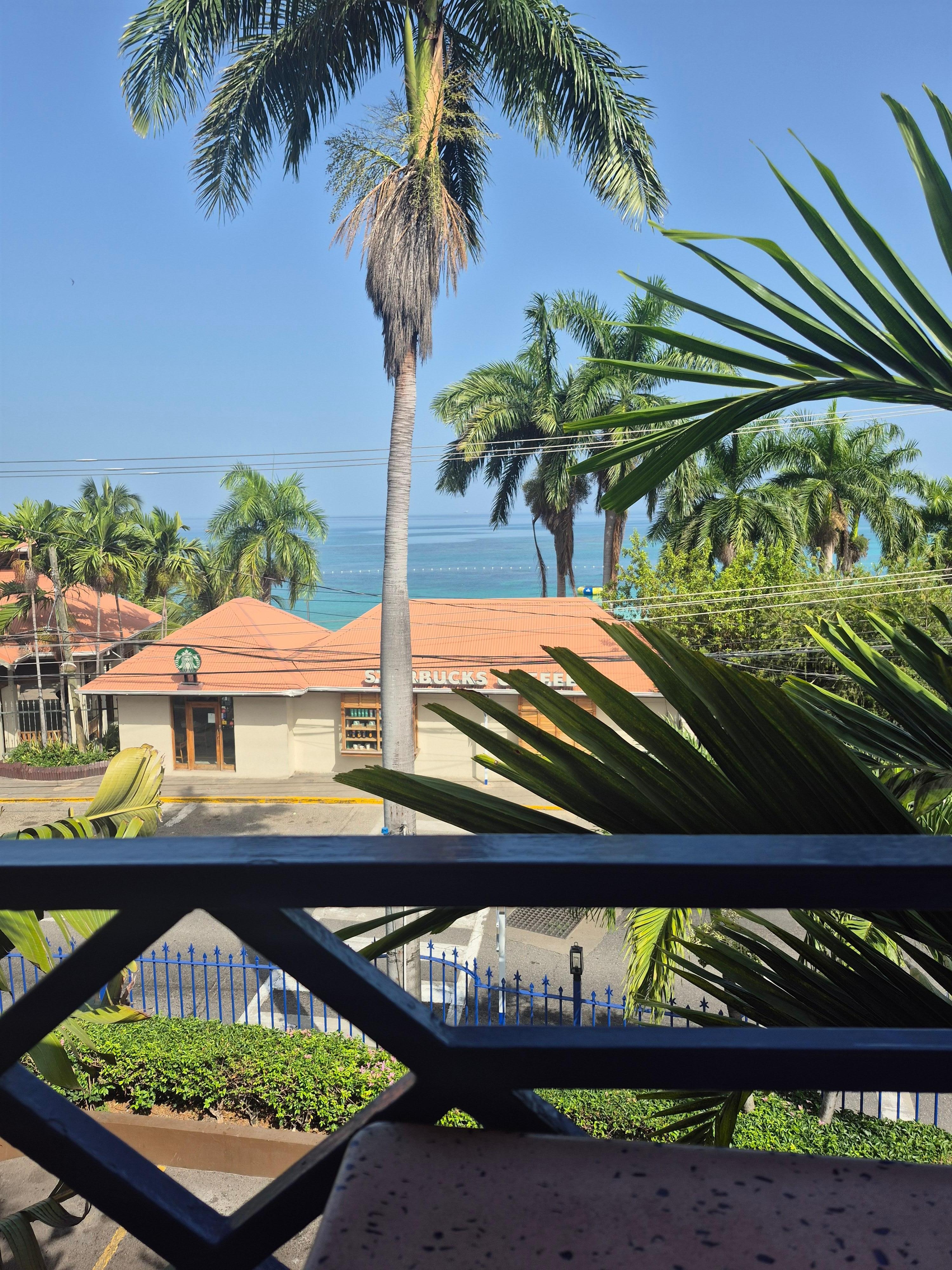 Balcony view facing Starbucks and the beach