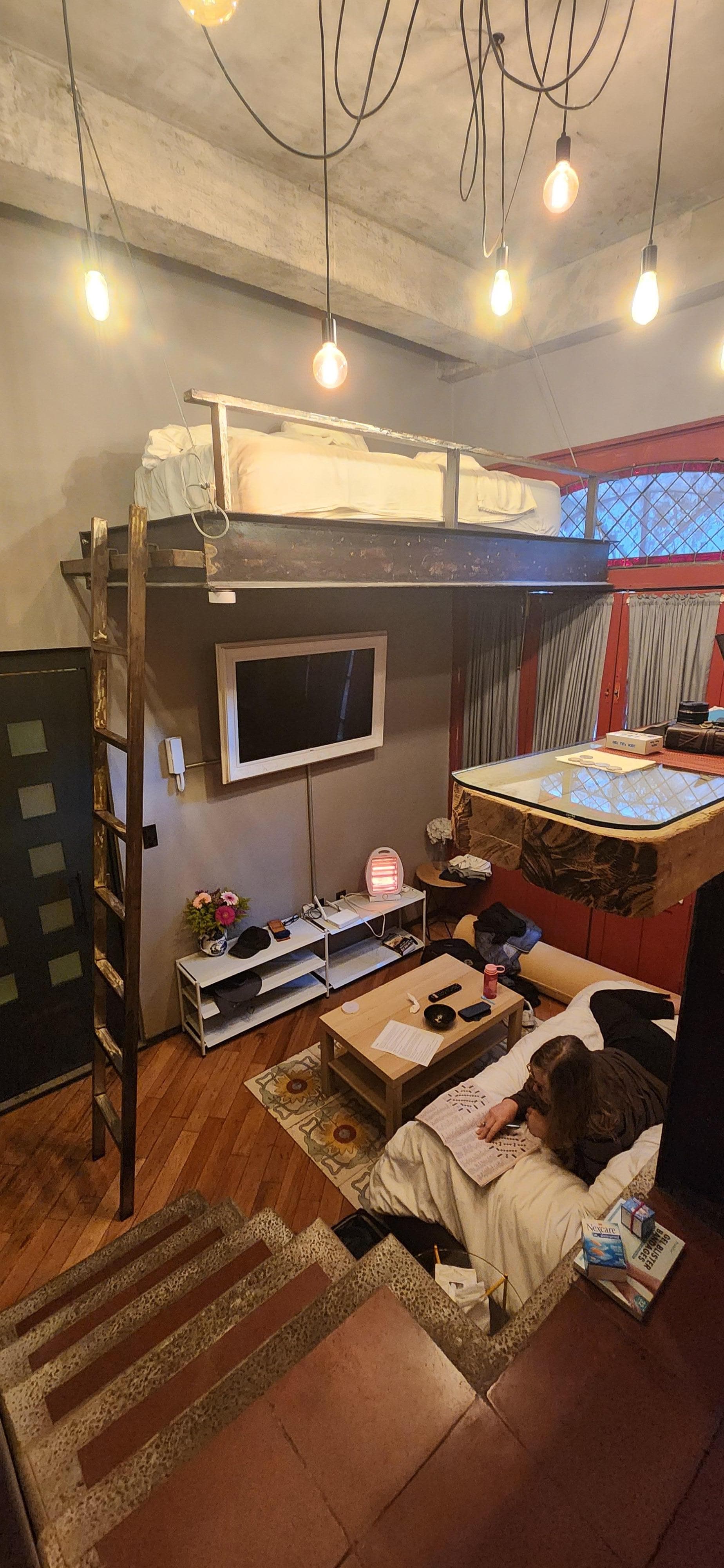 Looking across from bathroom/kitchen level. Bed is about 10' from the floor... fun!! The bed on the floor rolls under the kitchen & turns into a couch!