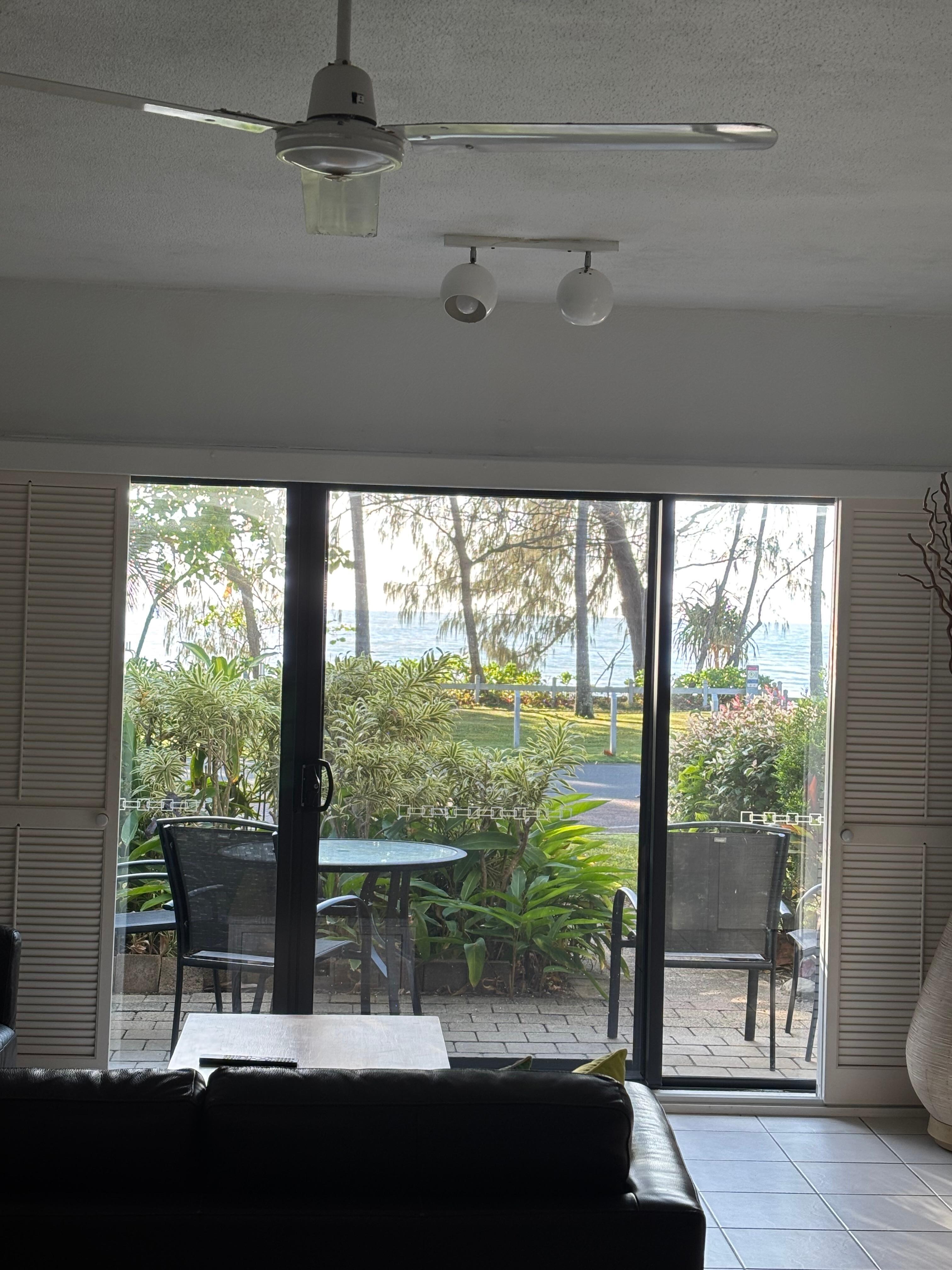 Living room looking out to bbq area and beach