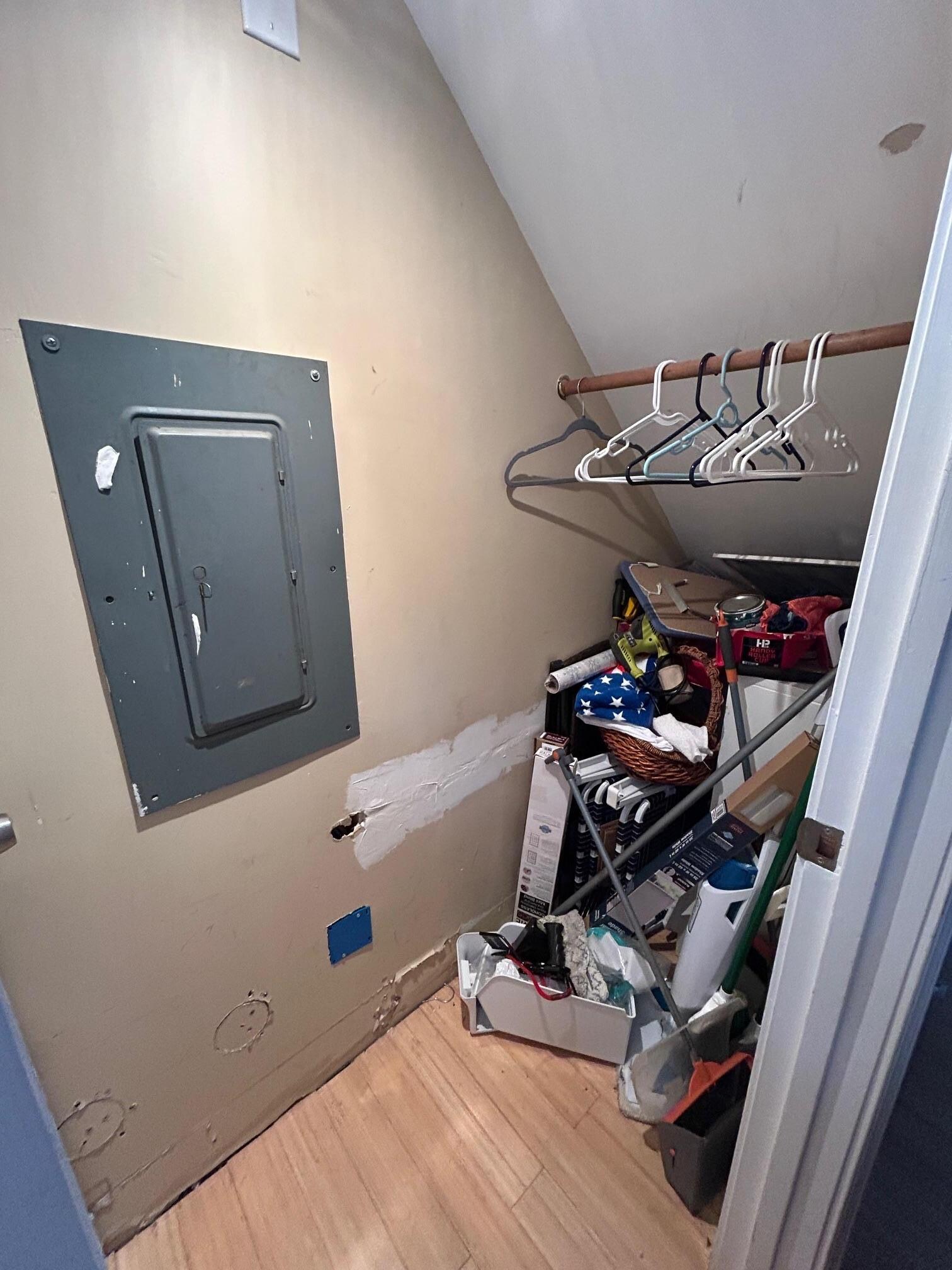 Downstairs bedroom closet piled with stuff. Not enough space to hang anything.