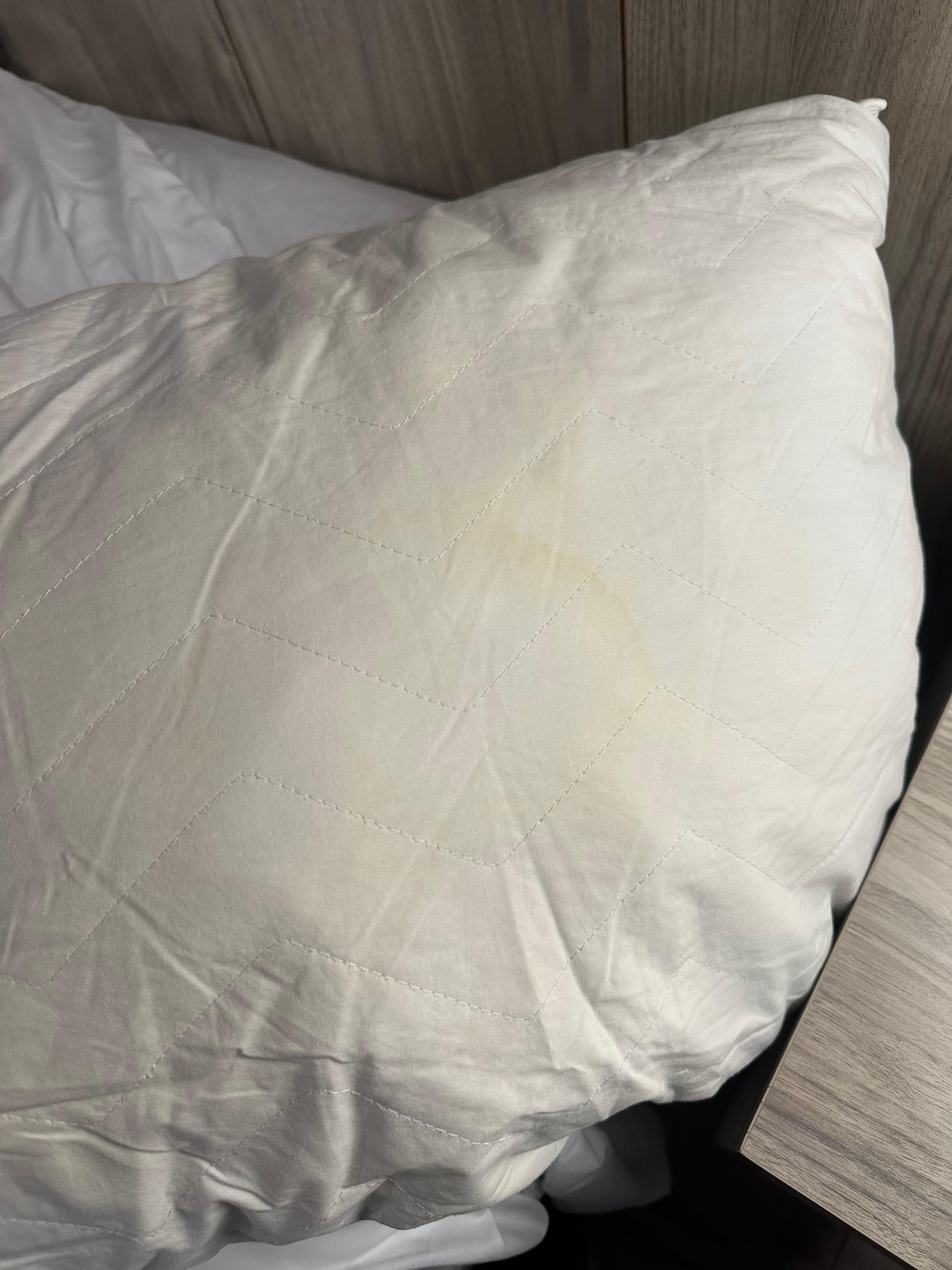 Yellow pillow stain, I feel like these types of things should be replaced at some point and not just covered with a new pillow cover 