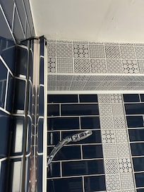 No shower curtain/glass & broken shower head.