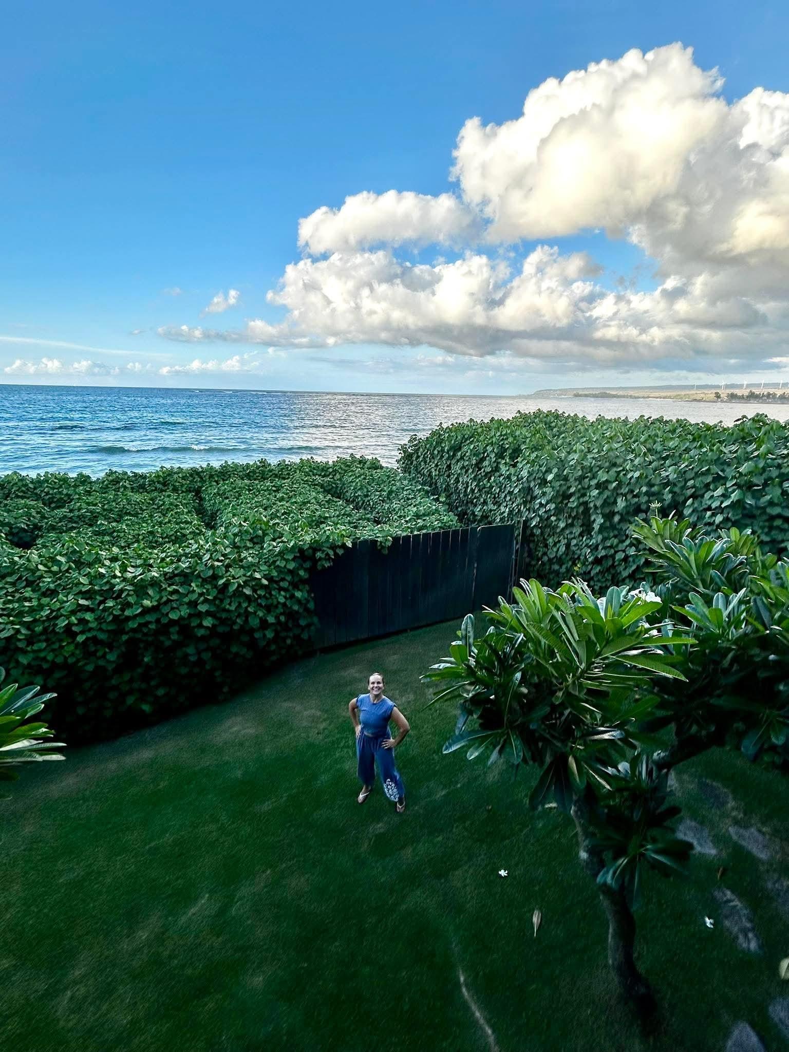 My daughter in the yard, view of the ocean.