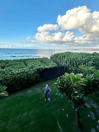 My daughter in the yard, view of the ocean.