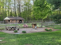 Outdoor fire pit, with chairs, wood, newspapers, etc