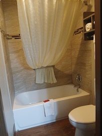 You'll definitely want to take advantage of this. Water at a perfect temperature in no time without waiting 20 minutes for it to heat up plus a shower head that actually works! They use the curved shower rod so the curtain doesn't touch you.