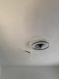 The gaping crack in the ceiling.