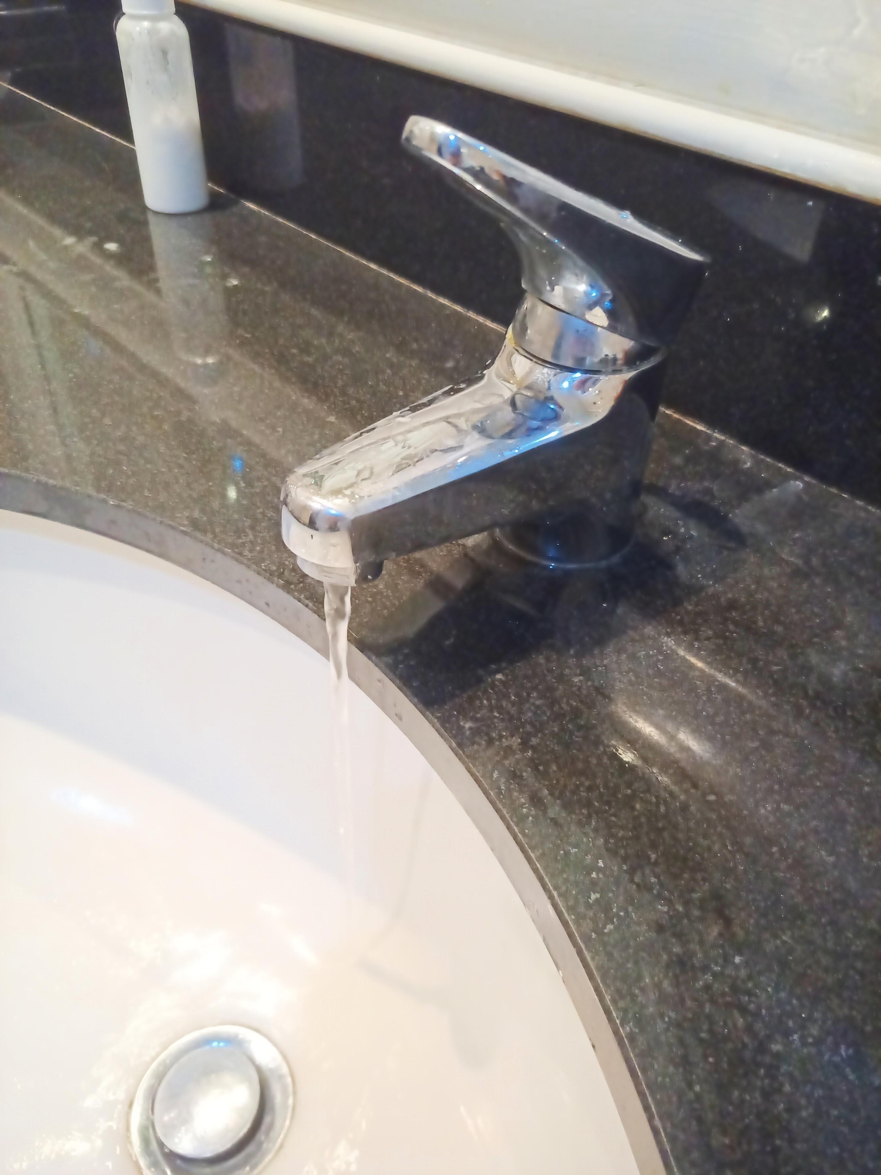 Bathroom sink tap at full blast.