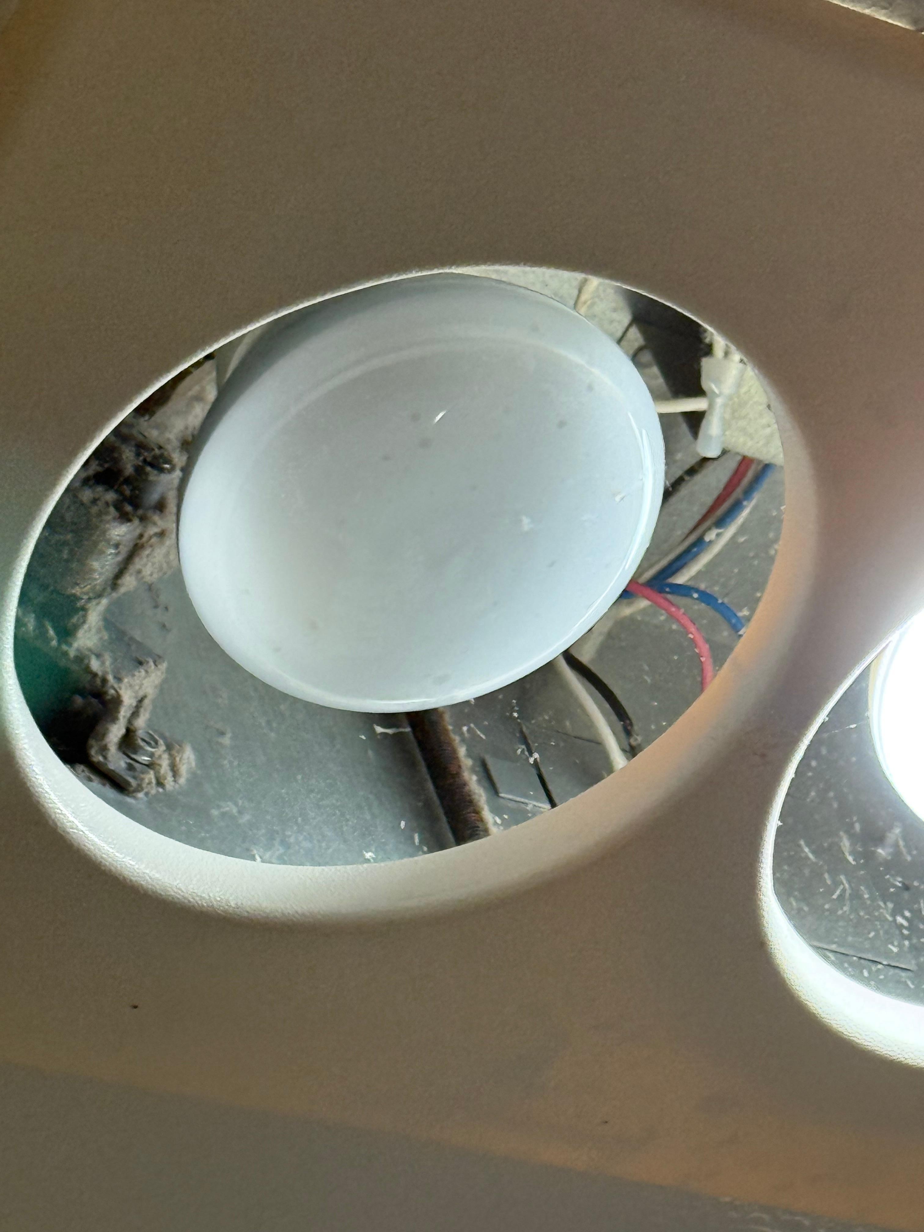 Lighting above the shower, missing the housing and exposing wires and insulation