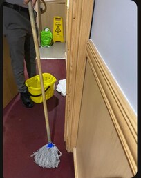 Night time person mopping up our flooded room.