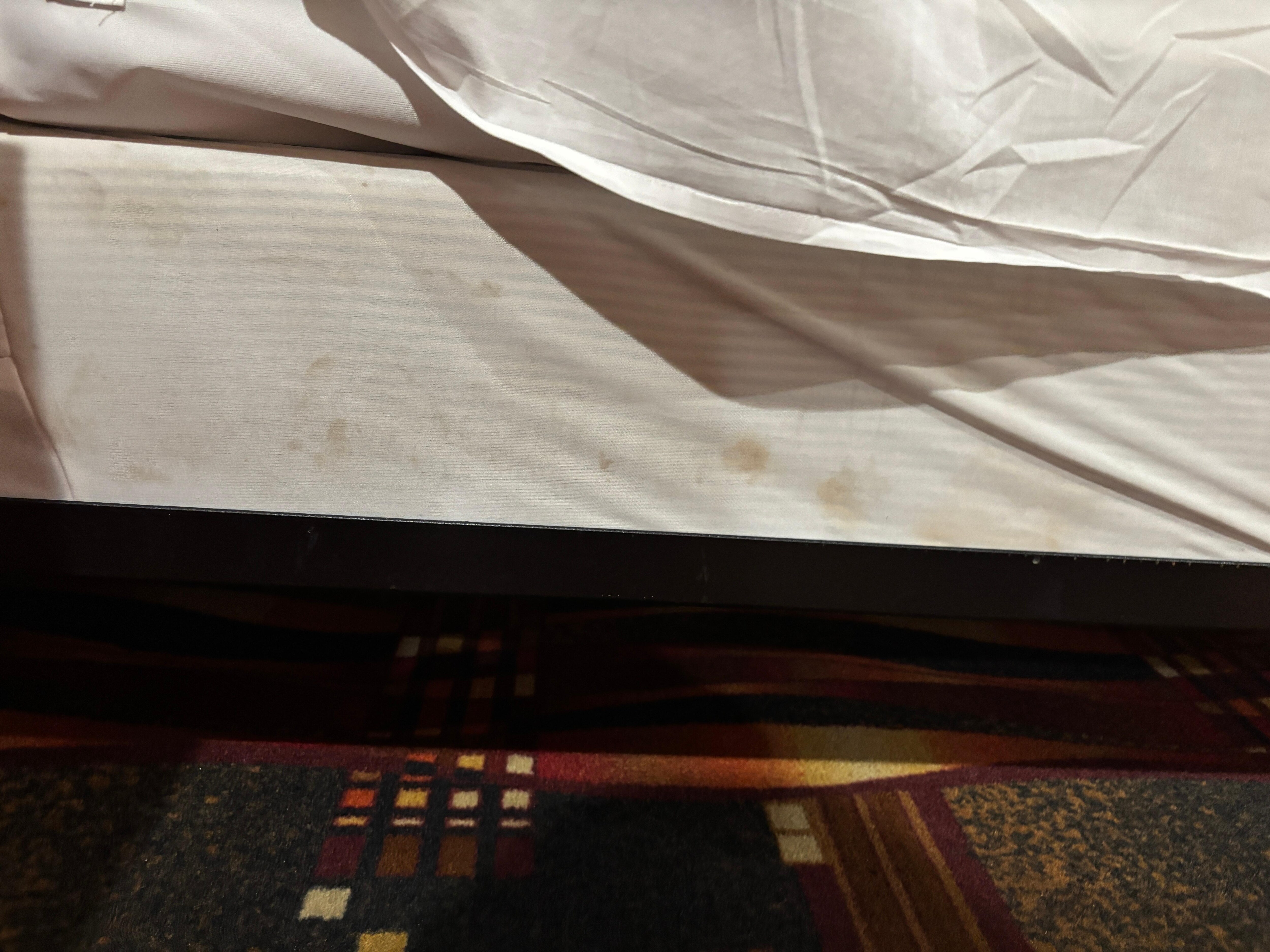 At bottom of bed