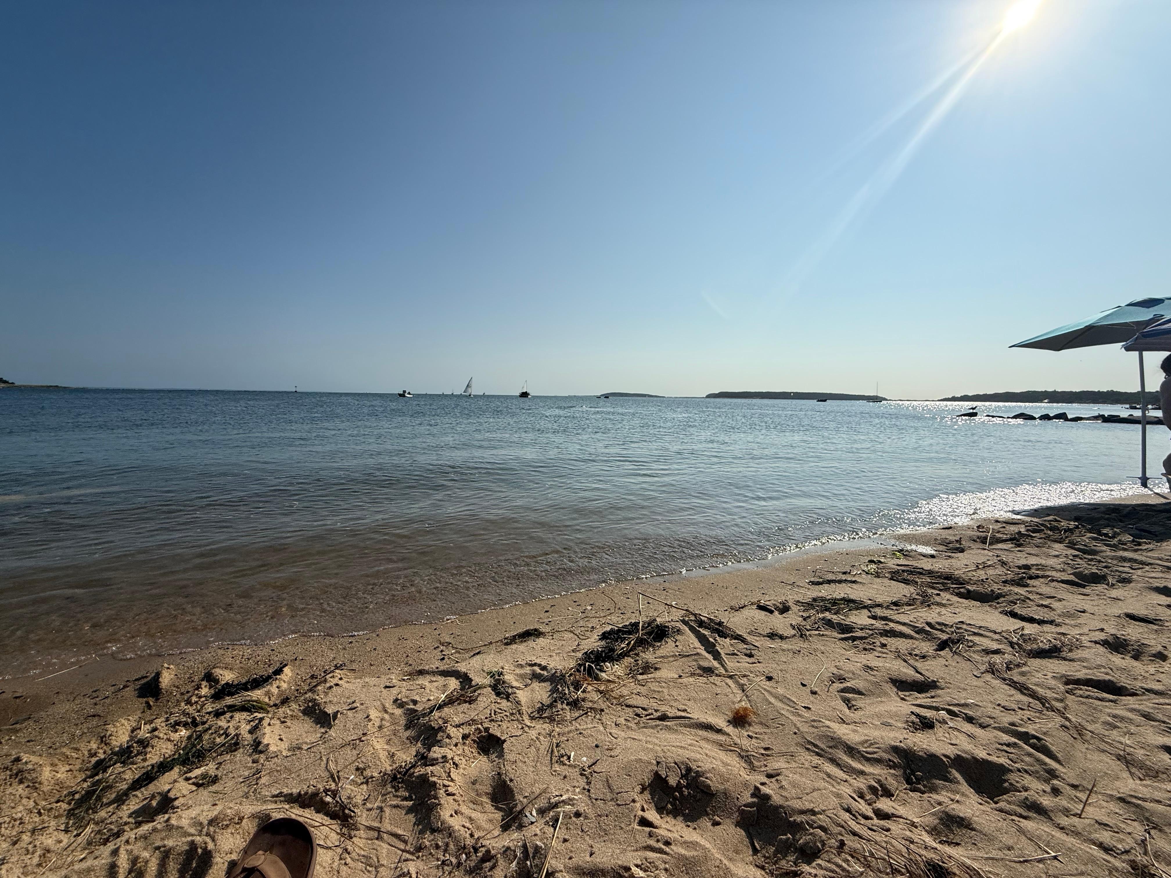 Bayside “Mayo Beach” is just past town with ample free public parking immediately adjacent to the sand. Great for small kids and accessible for older folks and people with health or orthopedic issues. Also faces the sun better than the ocean side. 